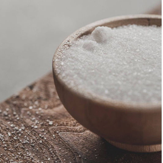 Granulated sugar in a wooden bowl